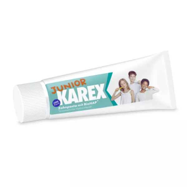 Tube de dentifrice KAREX Junior avec BioHAP, avec des enfants souriants se brossant les dents sur l'emballage.